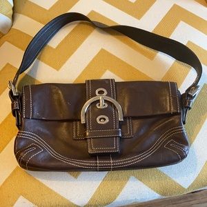 Brown leather coach shoulder bag.
